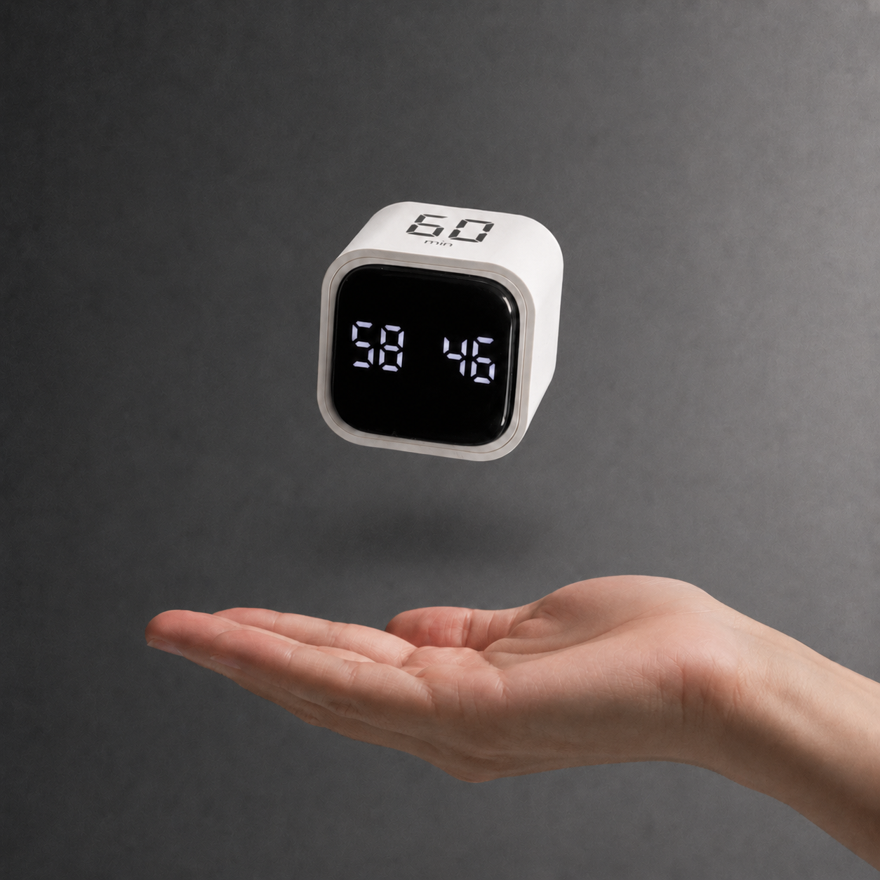 Compact black flip timer held above an open hand